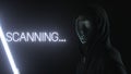 Unknown man wearing black mask and the light revealing SCANNING... text Royalty Free Stock Photo