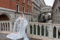 An unknown model poses in front of the Bridge of Sighs in Venice Royalty Free Stock Photo