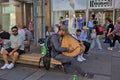 An unknown musician plays a plucked musical instrument.