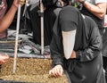 Unknown muslim woman wearing nikab or burka is choosing one of m