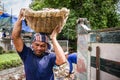 Unknown name Workers carrying fraction of cement up truck dumped