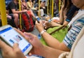 Unknown people uses mobile phone while travel by subway