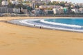 Unknown people walking on the beach called La Concha. Tourists in bay of Biscay in San Sebastian in autumn. Wide aerial beach. Royalty Free Stock Photo