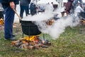 An unknown person prepares a traditional Romanian food prepared at the cauldron on the open fire Royalty Free Stock Photo