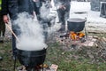 An unknown person prepares a traditional Romanian food prepared at the cauldron on the open fire Royalty Free Stock Photo