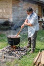 An unknown person prepares a traditional Romanian food prepared at the cauldron on the open fire Royalty Free Stock Photo