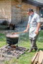 An unknown person prepares a traditional Romanian food prepared at the cauldron on the open fire Royalty Free Stock Photo