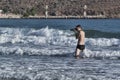 Unknown photographer takes pictures on the beach directly from the sea