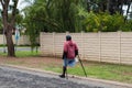 Unknown physically disabled man on crutches