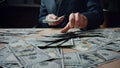 Man counting heap dollars at office desk close up. Calculating american money. Royalty Free Stock Photo