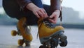 Unknown roller skater preparing to workout. Woman hands tying laces on skates. Royalty Free Stock Photo