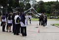 Unknown street artist makes big soap bubbles with two sticks and thread for group of women in Hyde Park