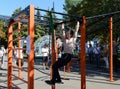 An unknown street athlete performs exercises on Poklonnaya Hill.