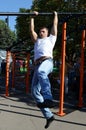 An unknown street athlete performs exercises on Poklonnaya Hill.