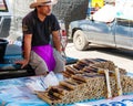 Unknown Street vendor of sticky rice in bamboo joints near famous Maeklong Railway Market