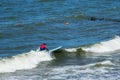 ZELENOGRADSK, KALININGRAD REGION, RUSSIA - JULY 29, 2017: Unknown surfer resting and having of surf on the blue waves.