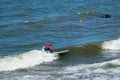 ZELENOGRADSK, KALININGRAD REGION, RUSSIA - JULY 29, 2017: Unknown surfer resting and having of surf on the blue waves.