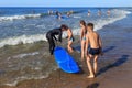 ZELENOGRADSK, KALININGRAD REGION, RUSSIA - JULY 29, 2017: Unknown surfers with surfboards and unknown children.