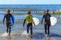 ZELENOGRADSK, KALININGRAD REGION, RUSSIA - JULY 29, 2017: Unknown surfers with surfboards standing in the blue water. Royalty Free Stock Photo