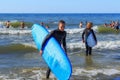 ZELENOGRADSK, KALININGRAD REGION, RUSSIA - JULY 29, 2017: Unknown surfers with surfboards standing in the blue water. Royalty Free Stock Photo