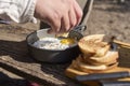 Unknown traveler eating breakfast outdoors, fried eggs and toasted bread slices Royalty Free Stock Photo