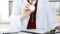 Unknown woman-doctor with a stethoscope in the hands. Physician is ready to examine a patient, close-up of hands Royalty Free Stock Photo