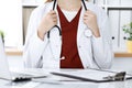 Unknown woman-doctor with a stethoscope in the hands. Physician is ready to examine a patient, close-up of hands Royalty Free Stock Photo