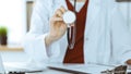 Unknown woman-doctor with a stethoscope in the hands. Physician is ready to examine a patient, close-up of hands Royalty Free Stock Photo