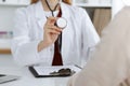 Unknown woman-doctor with a stethoscope in the hands. Physician is ready to examine a patient, close-up of hands Royalty Free Stock Photo