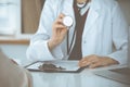 Unknown woman-doctor with a stethoscope in the hands. Physician is ready to examine a patient, close-up of hands Royalty Free Stock Photo