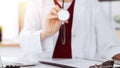 Unknown woman-doctor with a stethoscope in the hands. Physician is ready to examine a patient, close-up of hands Royalty Free Stock Photo