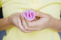 Unknown woman hands folding a menstrual cup