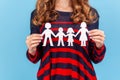 Unknown woman holding paper family chain, relationships between children and parents. Royalty Free Stock Photo