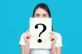 Unknown woman holding question mark. Girl holding paper question mark. Anonymous woman with question mark. Female person Royalty Free Stock Photo