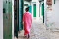 Unknown woman in national clothes on the old street in Tetouan Medina quarter in Northern Morocco. A medina is typically walled, Royalty Free Stock Photo