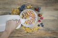 Unknown woman pouring milk into a cereal