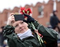 An unknown woman takes on the phone a military Victory parade on red Square.