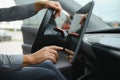 Unknown young man hand which typing needed coordinates on navigator touchscreen inside his modern car close up Royalty Free Stock Photo