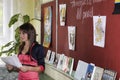 Unknown young teacher at the blackboard explains the material of the lesson