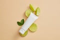 Unlabeled tube put on some Lime slices with leaves Royalty Free Stock Photo