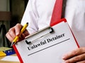 Unlawful detainer papers in the hands of man. Royalty Free Stock Photo