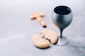 Unleavened bread, chalice of wine, wooden cross on grey background. Christian communion for reminder of Jesus sacrifice. Easter Royalty Free Stock Photo