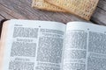 Unleavened bread matzo and an open Holy Bible Book on a rustic wooden table