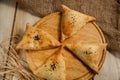 Unleavened puff pastry with minced meat filling on a wooden plate. Royalty Free Stock Photo