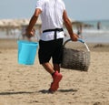 unlicensed street trader with bucket Royalty Free Stock Photo