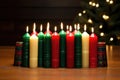 unlit kwanzaa candles arranged on a wooden table