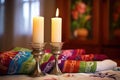 unlit shabbat candles with a torah and prayer shawl in the background