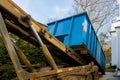 Unloading empty dumpster residential view of new houses being built and construction garbage Royalty Free Stock Photo