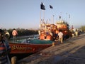 Unloading fishing boat beside the river and another side is totally full with mangrove forest