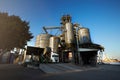 Unloading grain truck at elevator on elevating hydraulic platform unloader. Grain crops transshipment at big sea Royalty Free Stock Photo